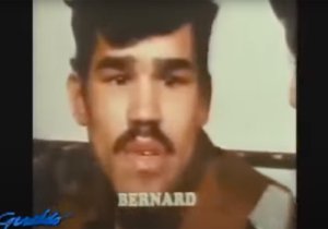 Video still from a news broadcast showing Bernard Carabello speaking.