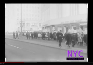 Black school boycotters holding signs in a protest march in downtown Brooklyn.