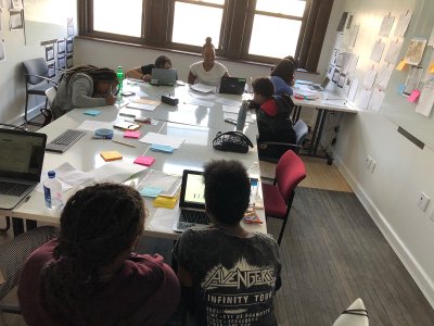 Classroom with students sitting around a table, shot from above